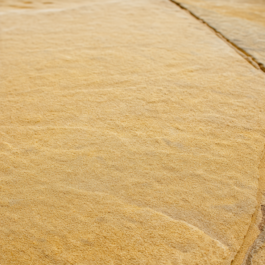 High Pressure Cleaning vs. Manual Scrubbing Melbourne Textured sandstone pathway surface with natural finish detail in warm daylight which needs to be maintained using high pressure cleaning services
