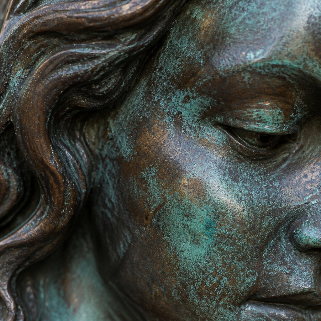 Close-up of bronze sculpture patina with green and brown aged finish