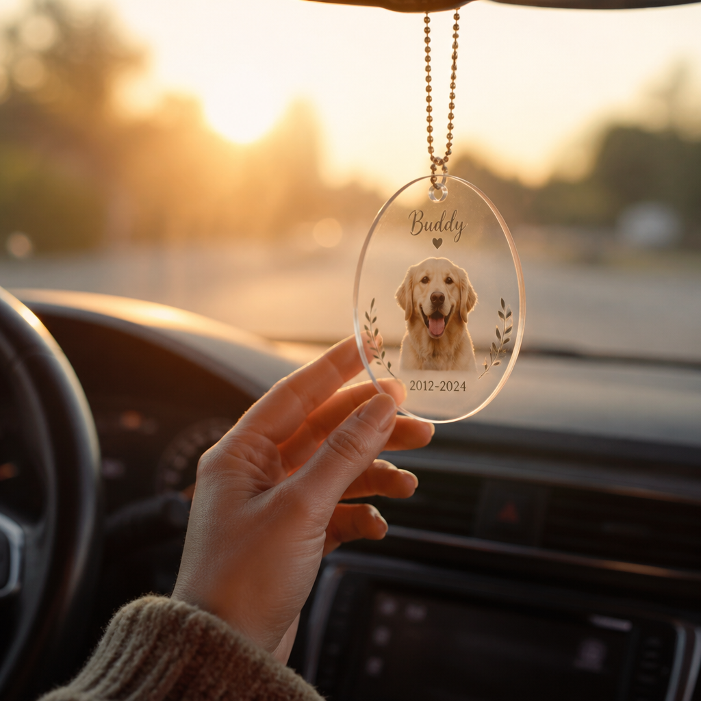 Hand reaching toward pet memorial ornament in car interior