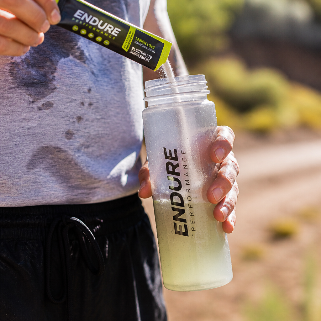 Athlete hydrating during exercise with electrolyte supplement during active training session
